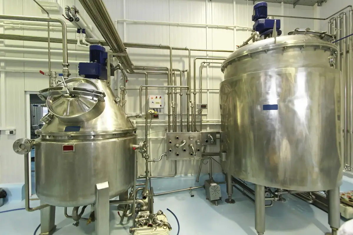 Stainless steel tanks and sanitary piping in a dairy processing plant