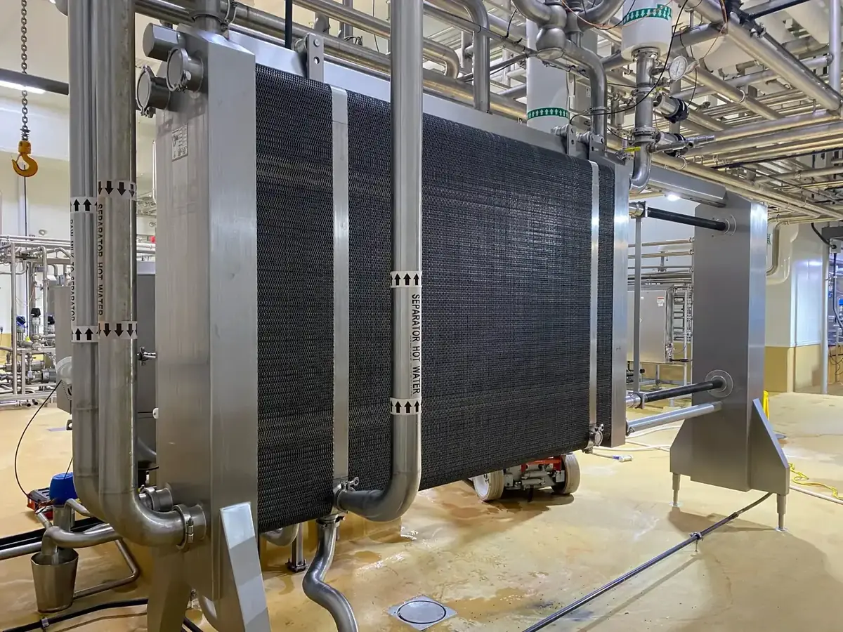 Plate heat exchanger opened for service with the plate pack exposed