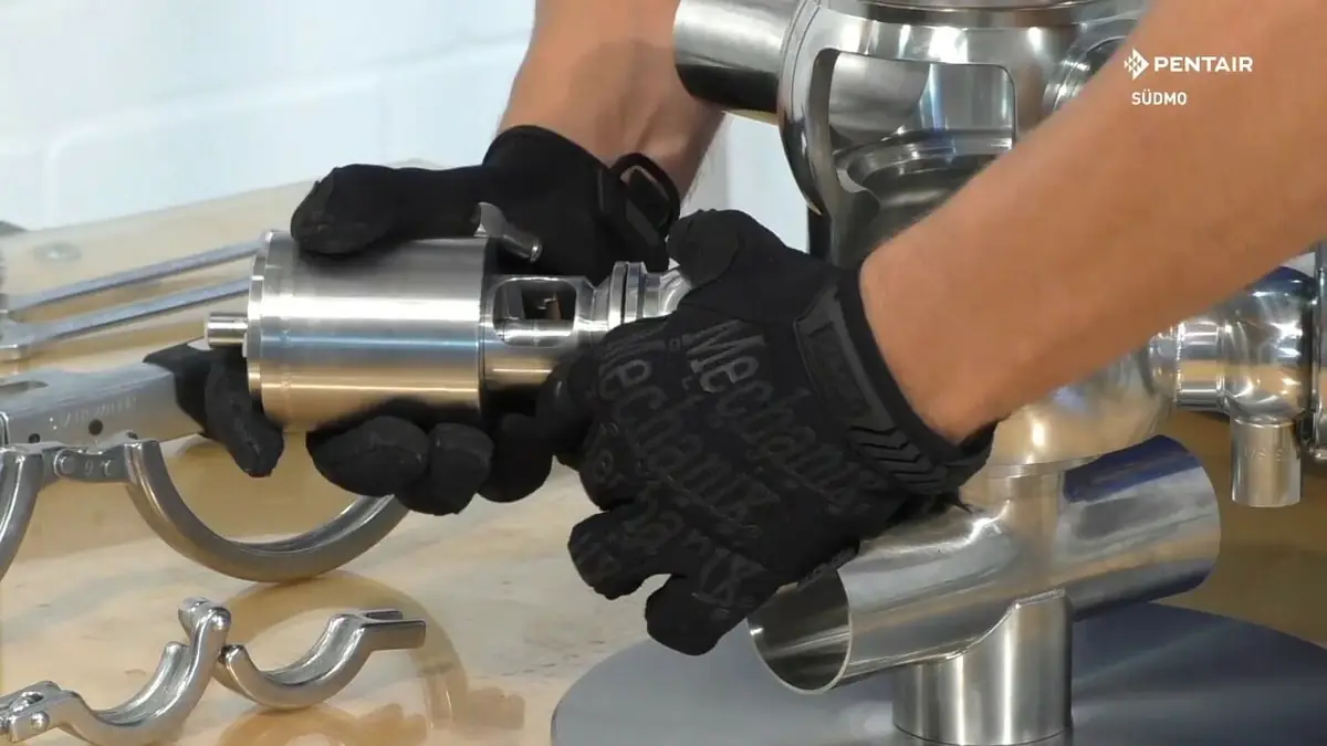 Technician demonstrating sanitary valve repair during hands-on maintenance work